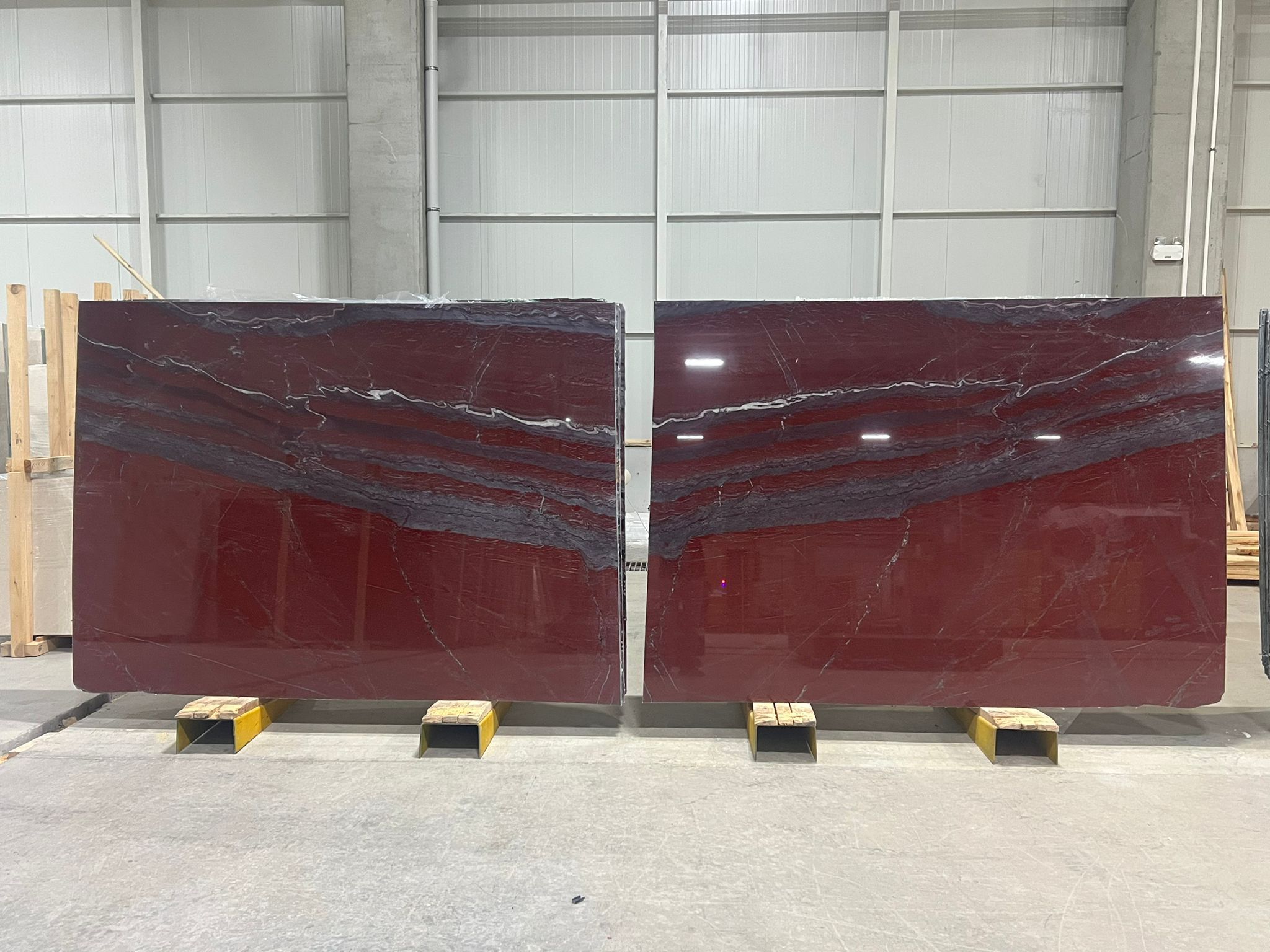 Vertical slab of polished Rosso Laguna marble